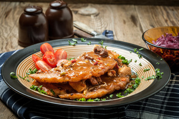 Potato pancakes with meat stew served on a plate.