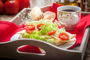 Delicious sandwich with tomatoes, cheese and lettuce.