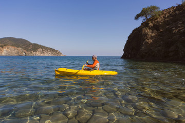 Fototapeta premium Men travel by canoe on the sea in the summer. 
