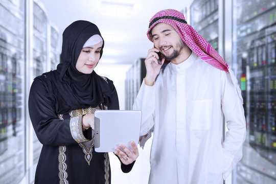 Arabic businesspeople working in server room