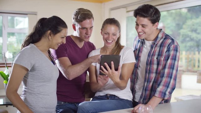  Happy young group of friends pose to take a selfie with computer tablet