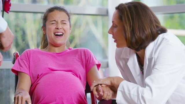 Pregnant woman going into labor concentrates on her breathing