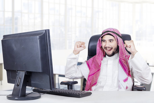 Cheerful middle eastern worker in the office