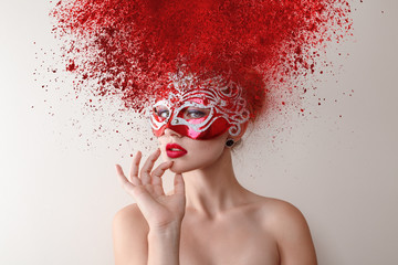 Fashion model with carnival mask