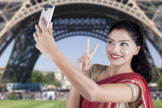 Indian woman takes selfie at Eiffel Tower
