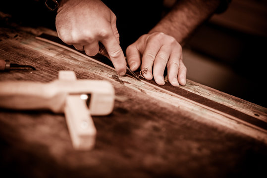 Leather goods craftsman at work in his workshop