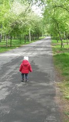 Little girl walking in the park