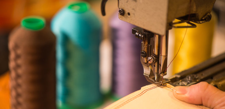 Leather goods craftsman at work in his workshop