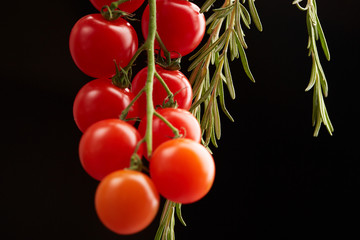 cherry tomatoes on a black background