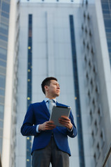 Korean businessman working with the tablet in the business district