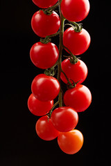 cherry tomatoes on a black background