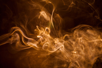 Golden smoke on black background.