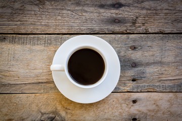 cup of coffee on wood table background