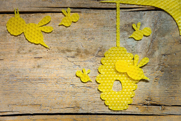 beeswax, bees and a beehive on wooden table, copyspace