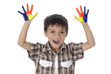 happy little boy with painted hands.