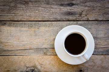 cup of coffee on wood table background