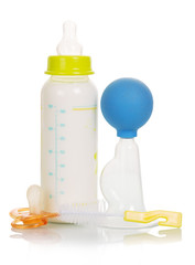 Breast pump, baby bottle and brush isolated on white 