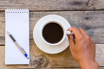 cup of coffee  with paper note on wood table background