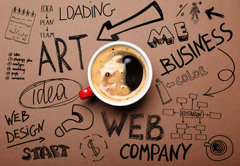 Cup of coffee on brown background, top view. Start up concept