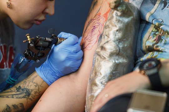 Tattooist makes a tattoo. Closeup