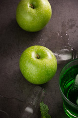 green apples and apple slices on gray background, top view

