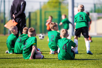 Fototapeta premium Youth soccer team together watching football game. Soccer tourna