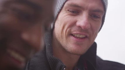 Happy male friends looking down at computer tablet which is out of shot - Powered by Adobe
