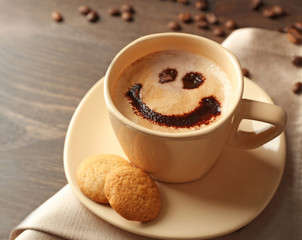 Cup of coffee on wooden table background