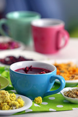 Cup of tea with aromatic dry tea on wooden background