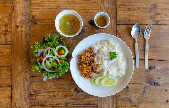 Pork fried with garlic and rice in white disk