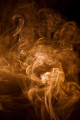 Orange smoke on a black background.
