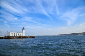 Obraz premium Scarborough lighthouse viewed from the harbour. In Scarborough, England. On 5th May 2016.