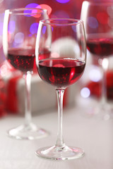 Wineglasses on red blurred lights background