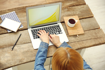 Fototapeta premium Woman working on a laptop at office desk