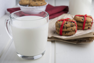 Very sweet retro bottle of milk with cookie on old table