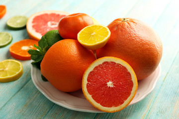 Juicy composition of tropical fruits on wooden background