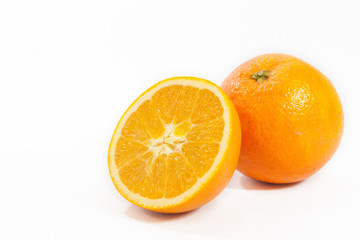 Sliced orange fruit with leaves isolated on white background
