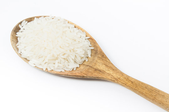 rice and a wooden spoon on a white background.