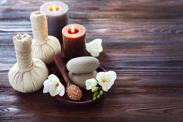 Spa composition with alight candles and beautiful flowers on wooden background
