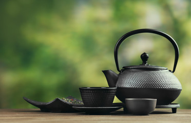 Black pialats and teapot on blurred background