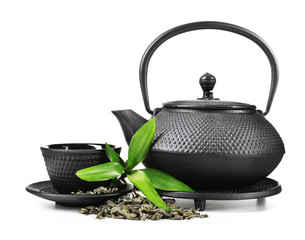 Green tea with black utensils, isolated on white