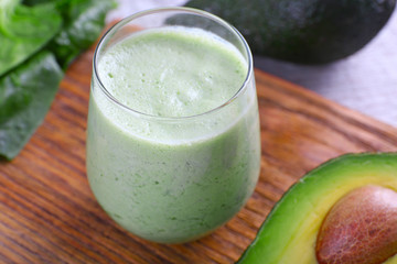 Avocado smoothie on wooden cutting board closeup