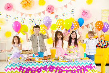 Happy group of children having fun at birthday party