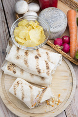a healthy wrap with turkey, greens and cheese