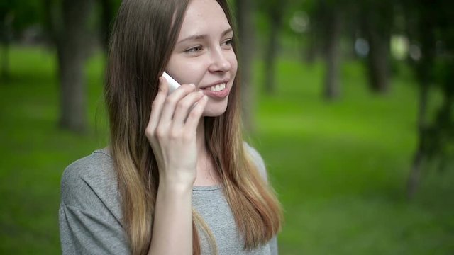 girl talking on the phone in the forest