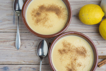 Traditional creme brulee on ceramic dish on wooden table