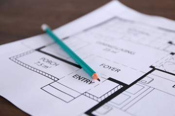 Construction drawings with pencil on wooden table closeup