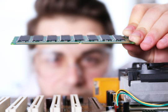 Man fixing electronic circuits closeup