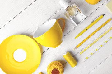 Yellow colour flat lay composition on white wooden background