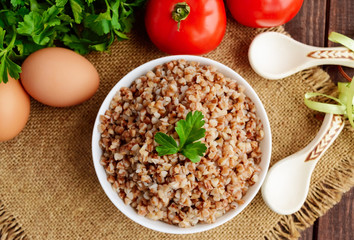 Buckwheat porridge in white bowl. Dietary dish. Vegan. top view